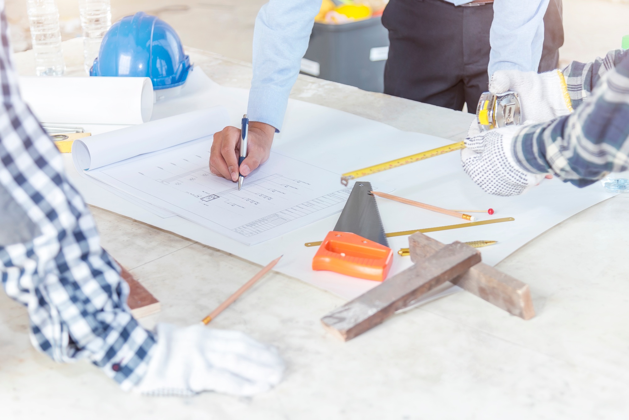 Civil engineer and foreman meeting and working on blueprint.